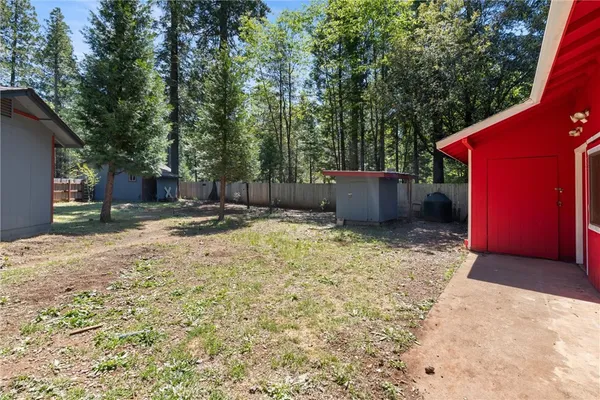 a backyard of a house with yard and tree