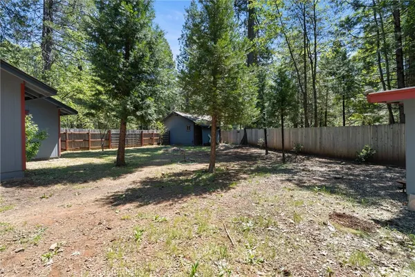 a view of a house with a yard and tree s