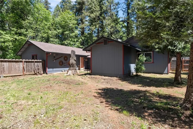 a backyard of a house with barbeque oven