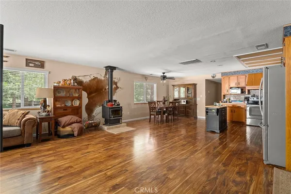a living room filled with furniture and kitchen view