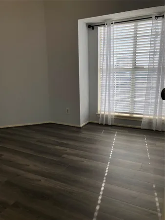 a view of a door with wooden floor