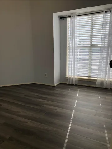 a view of a door with wooden floor