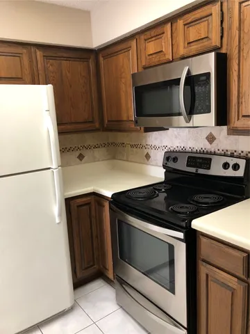 a kitchen with granite countertop cabinets and steel stainless steel appliances