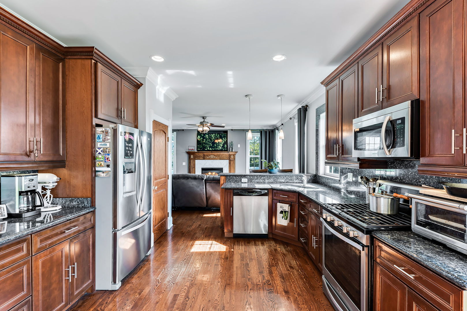 2002 Sandstone Trail Kankakee, IL 60901 - Photo 11 of 27 a kitchen with stainless steel appliances granite countertop a refrigerator a stove top oven a sink dishwasher and wooden cabinets with wooden floor