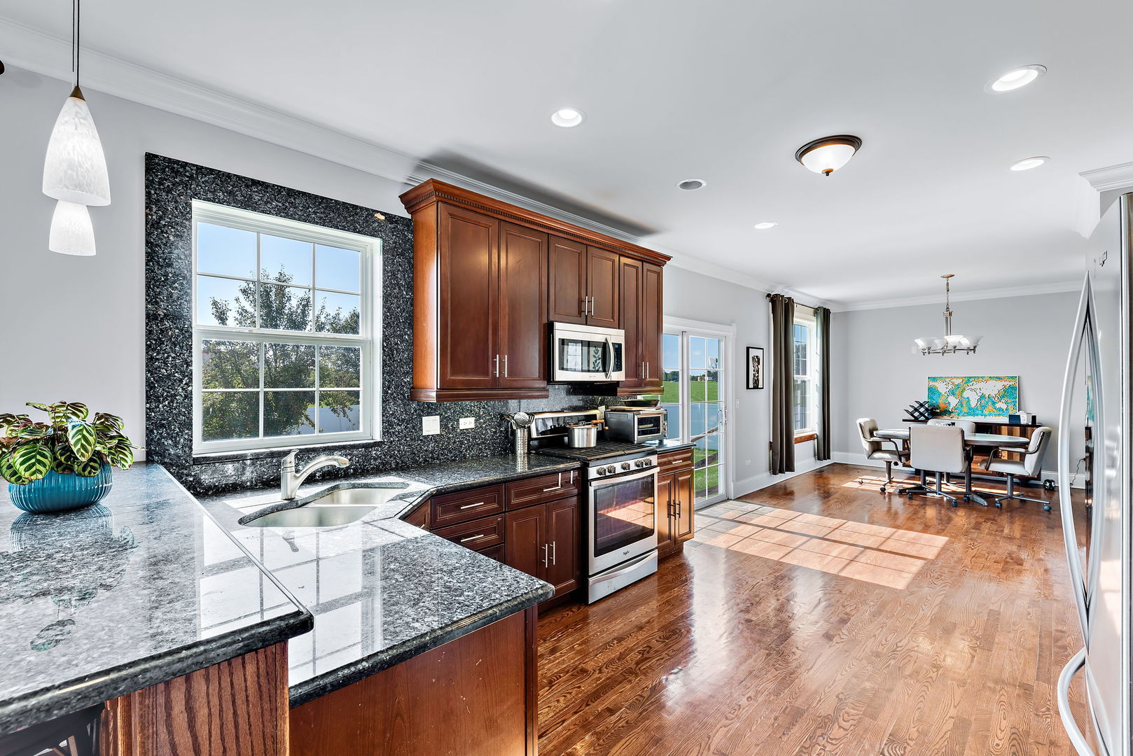 2002 Sandstone Trail Kankakee, IL 60901 - Photo 12 of 27 a kitchen with stainless steel appliances granite countertop sink stove and large window