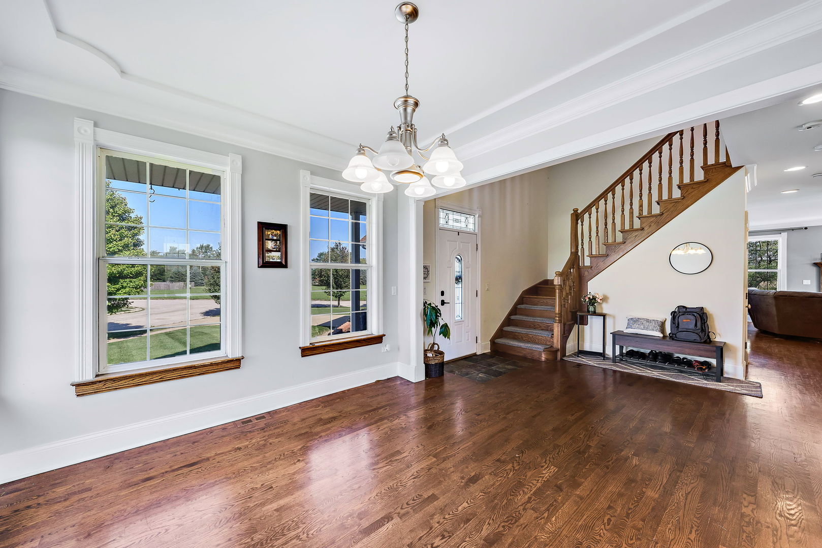 2002 Sandstone Trail Kankakee, IL 60901 - Photo 4 of 27 a view of a livingroom with wooden floor stairs and a fireplace