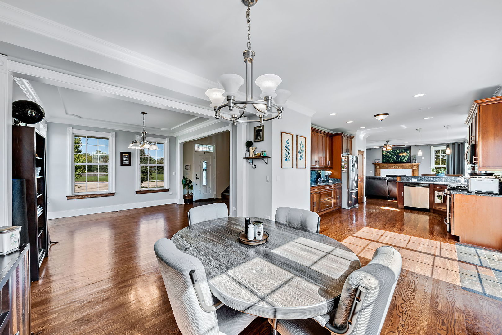 2002 Sandstone Trail Kankakee, IL 60901 - Photo 6 of 27 a view of a dining room and livingroom with furniture wooden floor a chandelier