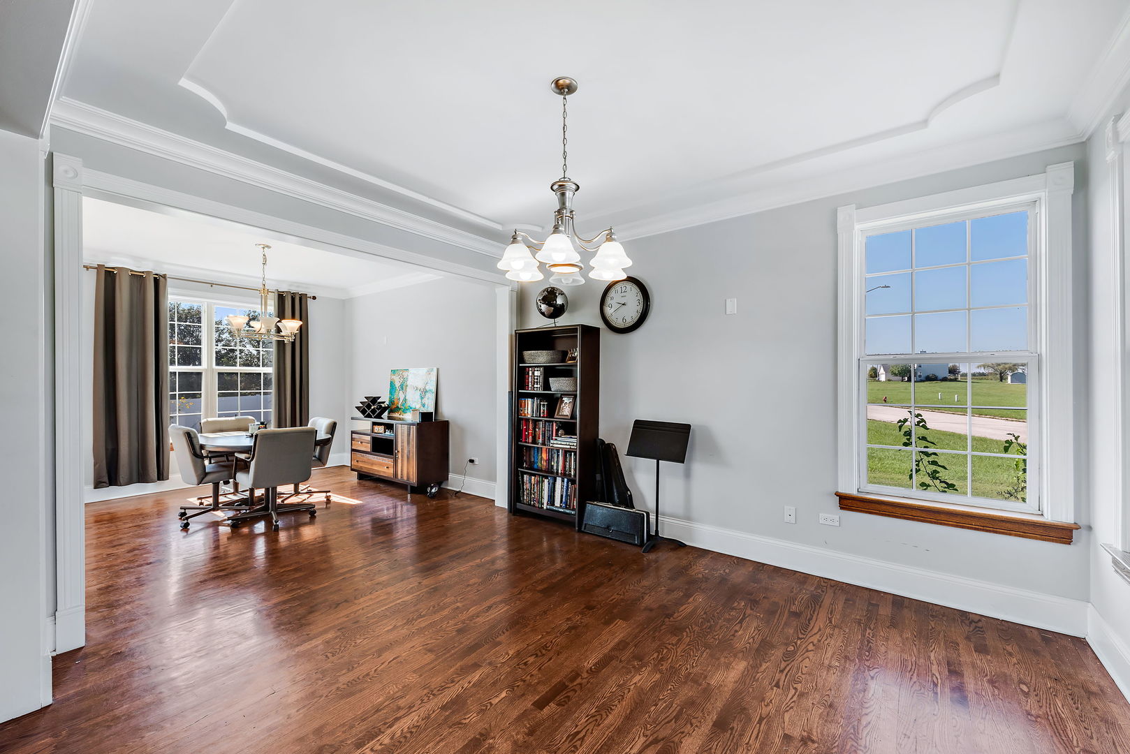 2002 Sandstone Trail Kankakee, IL 60901 - Photo 7 of 27 a view of a dining room and livingroom with furniture wooden floor a rug a fireplace and a chandelier