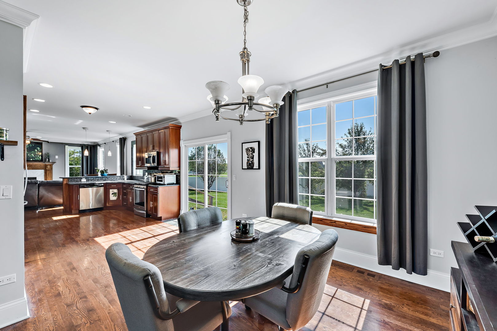 2002 Sandstone Trail Kankakee, IL 60901 - Photo 9 of 27 a dining room with furniture a chandelier and wooden floor