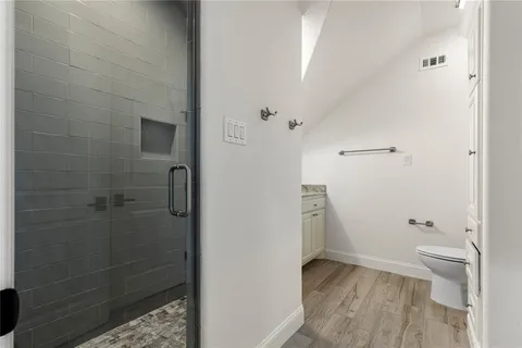 a bathroom with a toilet and a shower