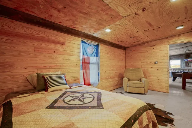 a bedroom with furniture and a wooden floor