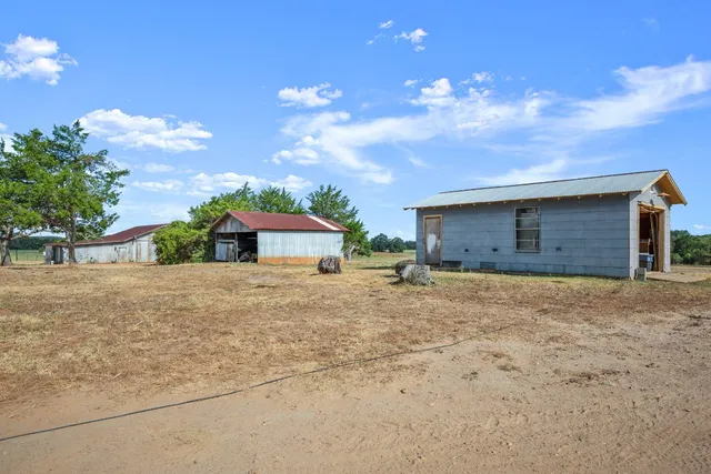 a view of a house with a yard and garage