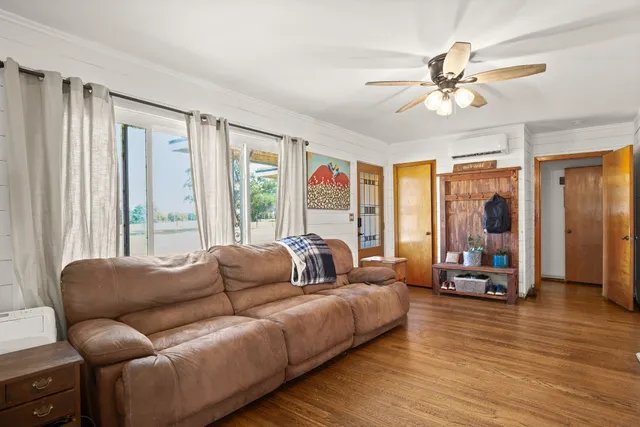 a living room with furniture and large windows