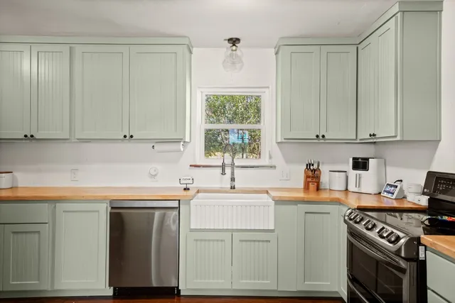 a kitchen with a sink stove and cabinets