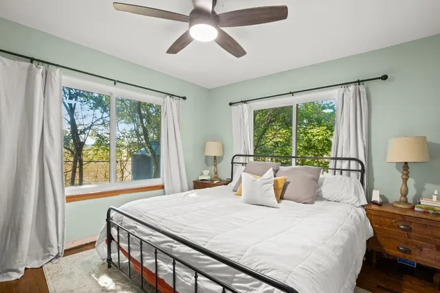 a bedroom with a large bed and a large window