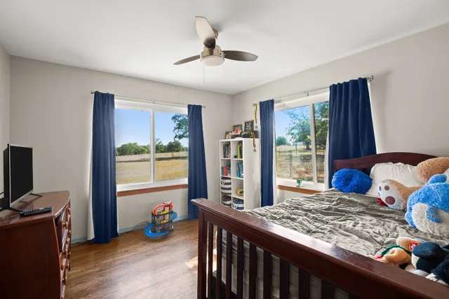 a bedroom with furniture and a window