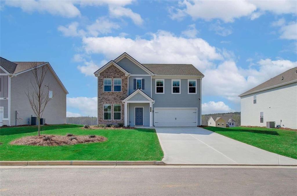 a front view of a house with a yard and garage