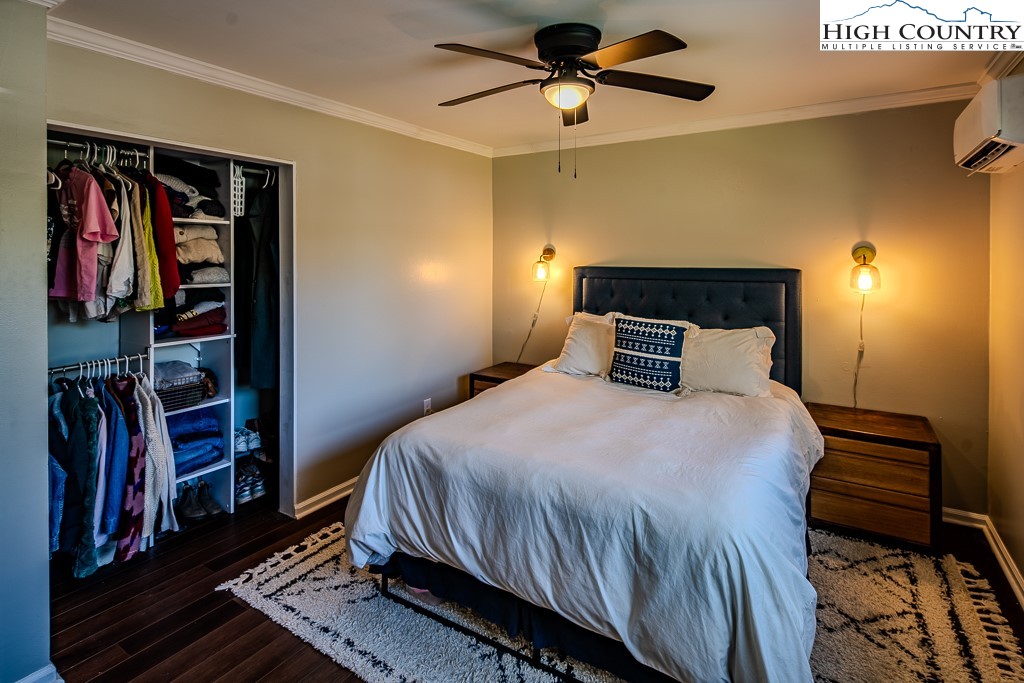 477 Hardaman Circle Boone, NC 28607 - Photo 20 of 48 a bedroom with a large bed and a chandelier