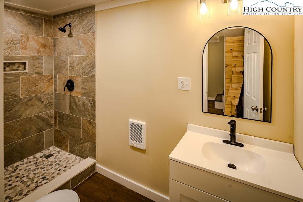 477 Hardaman Circle Boone, NC 28607 - Photo 23 of 48 a bathroom with a sink a mirror and shower