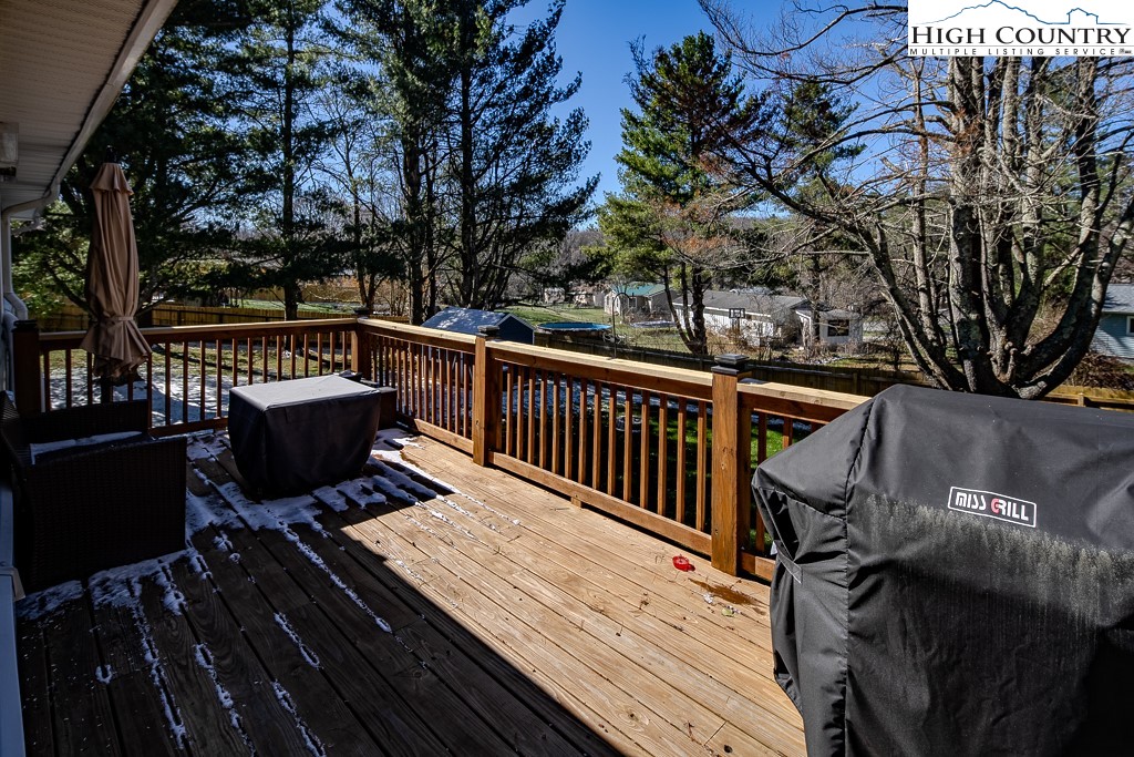 477 Hardaman Circle Boone, NC 28607 - Photo 43 of 48 a view of a roof deck with table and chairs and wooden fence