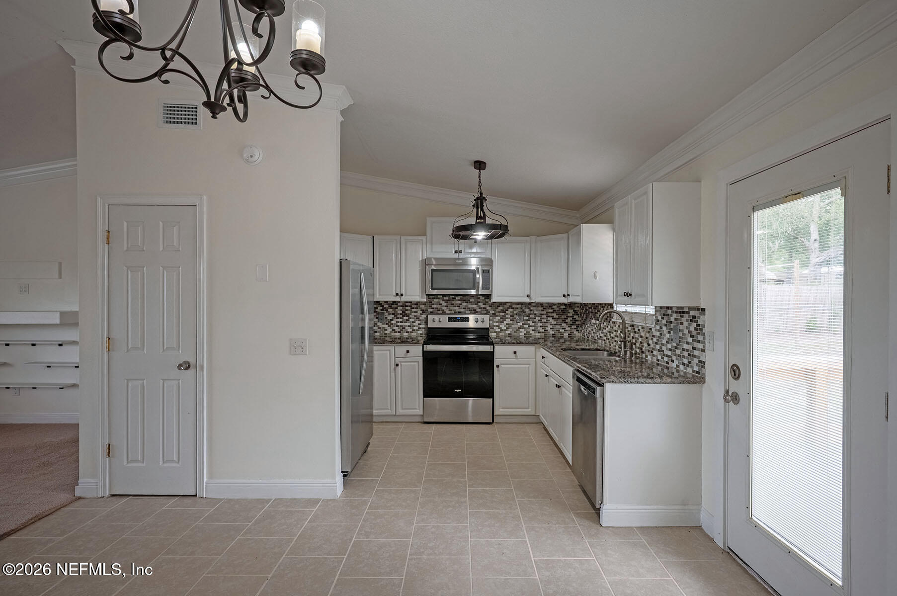 430 Southwest Jasmine Avenue Keystone Heights, FL 32656 - Photo 9 of 37 a kitchen with stainless steel appliances granite countertop a stove and a refrigerator