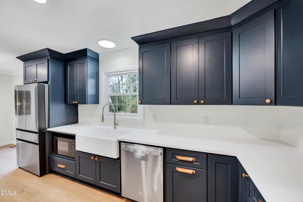 a kitchen with a sink cabinets and stainless steel appliances