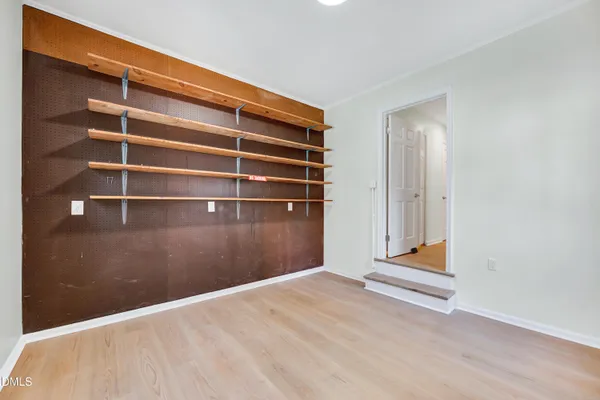 a view of an empty room with empty shelves
