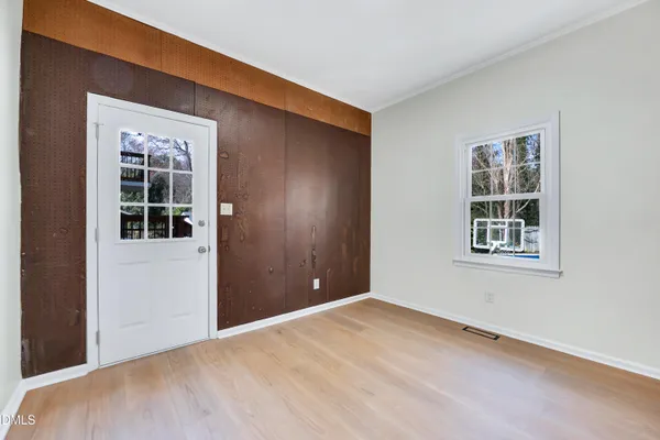 a view of a big room with windows and chandelier