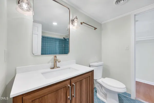 a bathroom with a sink toilet and mirror