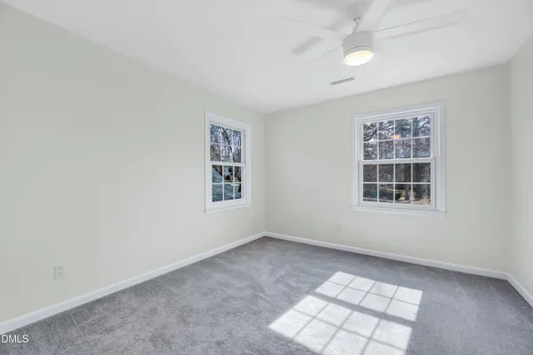 an empty room with windows and closet