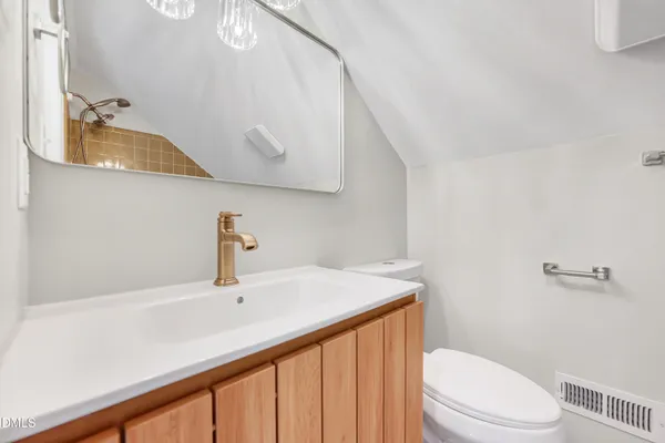 a bathroom with a sink a toilet and shower curtain
