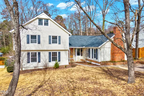 a front view of a house with a yard covered in snow
