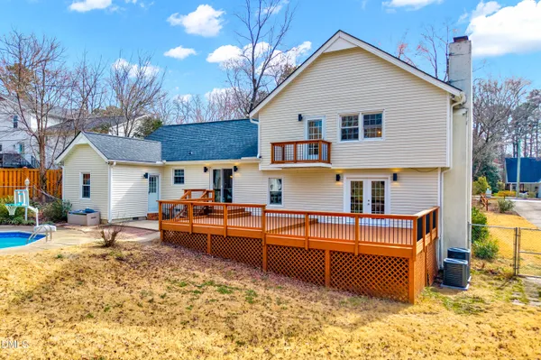 a view of a house with backyard and sitting area