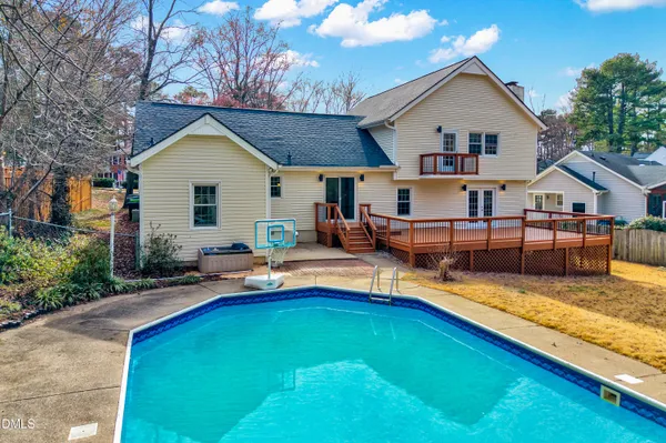 a view of a house with pool and chairs