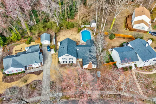 an aerial view of a house with a yard and lake view