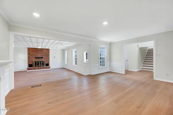 an empty room with windows and cabinet