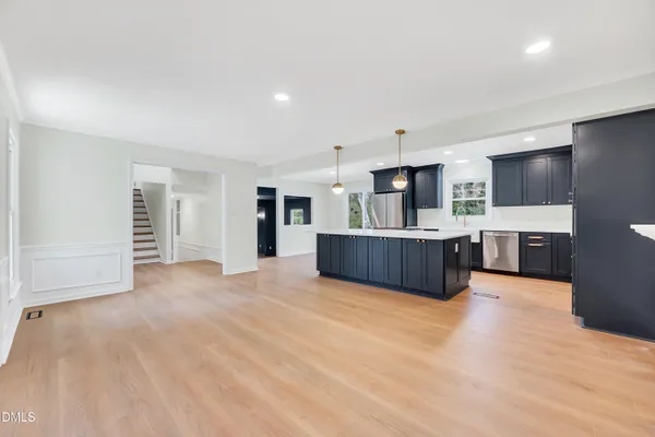 a large room with furniture and flat screen tv