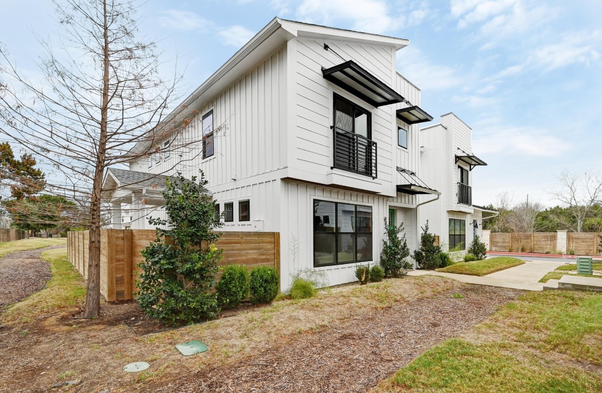 7601 Cooper Lane, Unit 6 Austin, TX 78745 - Photo 2 of 29 View of side of home featuring board and batten siding and a balcony