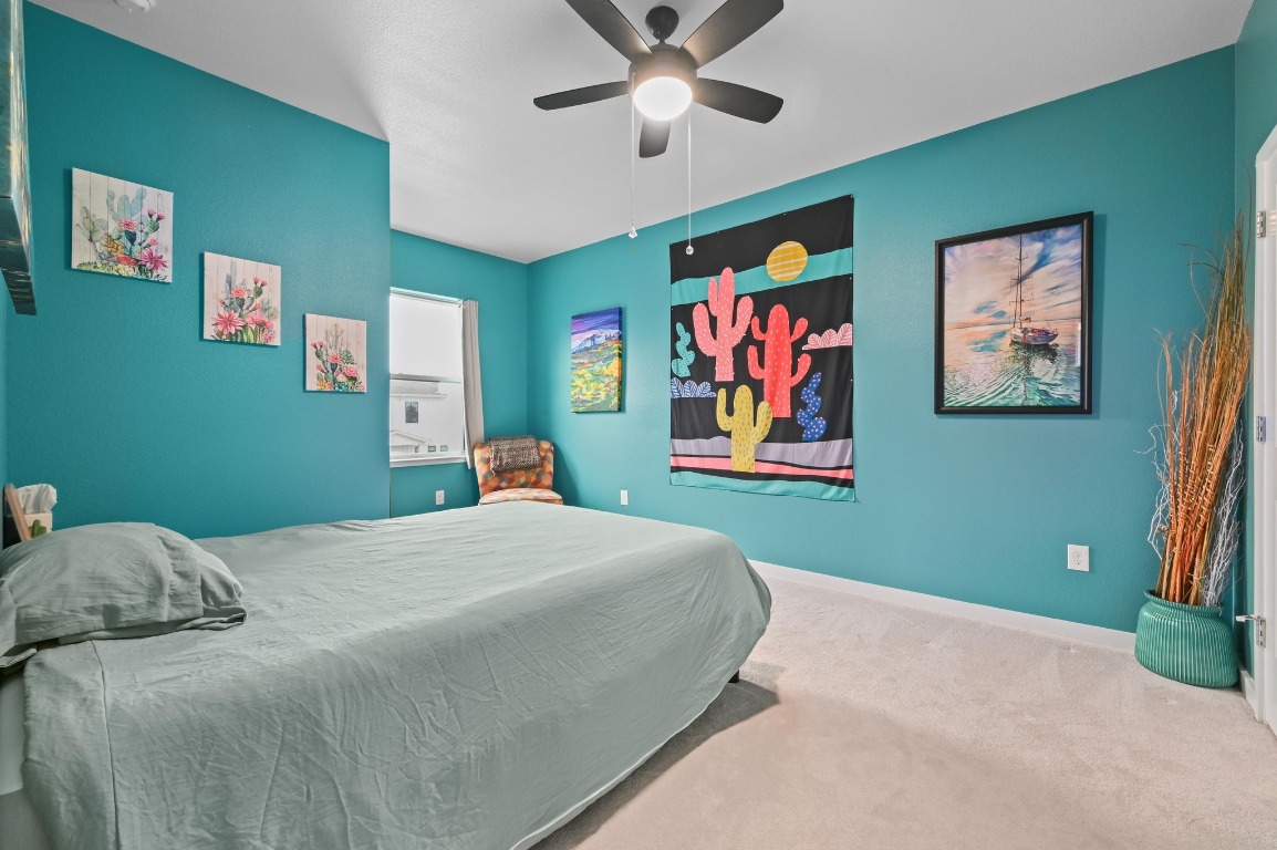 7601 Cooper Lane, Unit 6 Austin, TX 78745 - Photo 22 of 29 a bedroom with a bed and a painting on the wall
