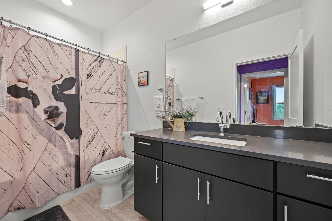 7601 Cooper Lane, Unit 6 Austin, TX 78745 - Photo 23 of 29 a bathroom with a granite countertop sink toilet and shower