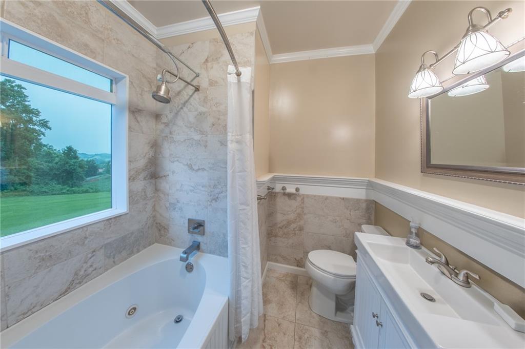 1815 Pickens Street Ball Ground, GA 30107 - Photo 14 of 38 a bathroom with a granite countertop sink a toilet and shower