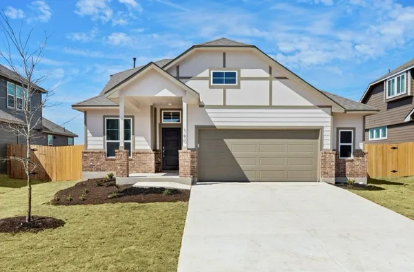 a view of a white house with a small yard