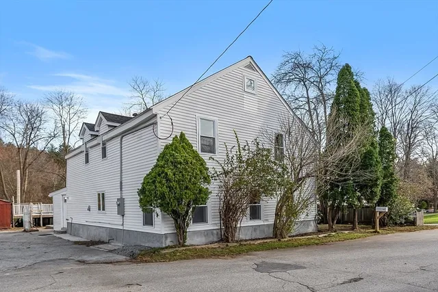 a house that has a tree in front of it