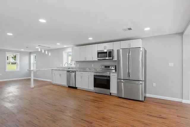 a kitchen with a refrigerator and a sink