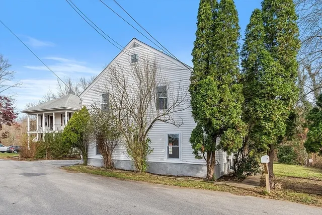 a view of a house with a tree and plants