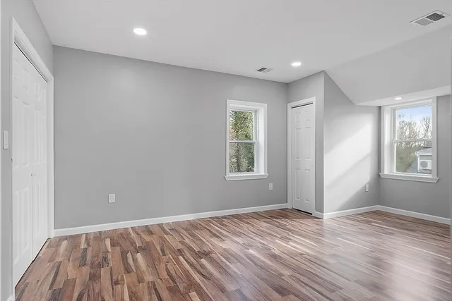 wooden floor in an empty room with a window