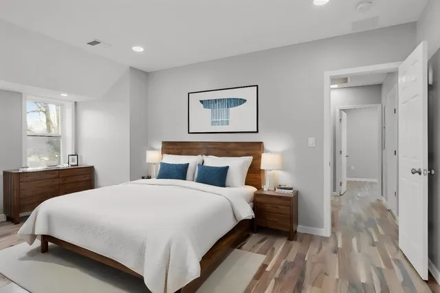 a bedroom with a bed and a mirror