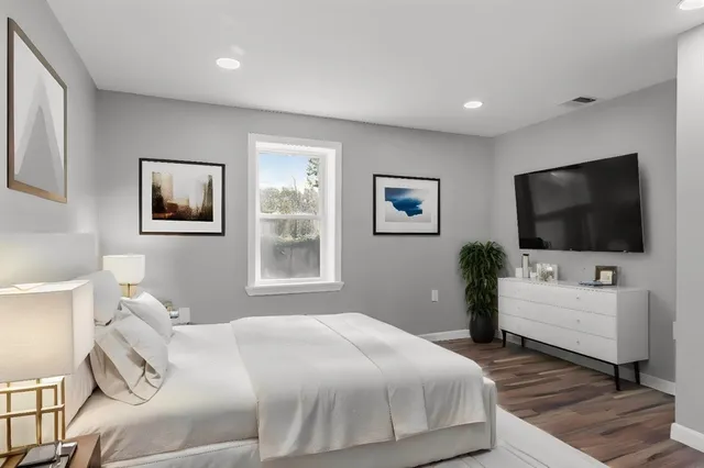 a bedroom with a bed and a flat screen tv