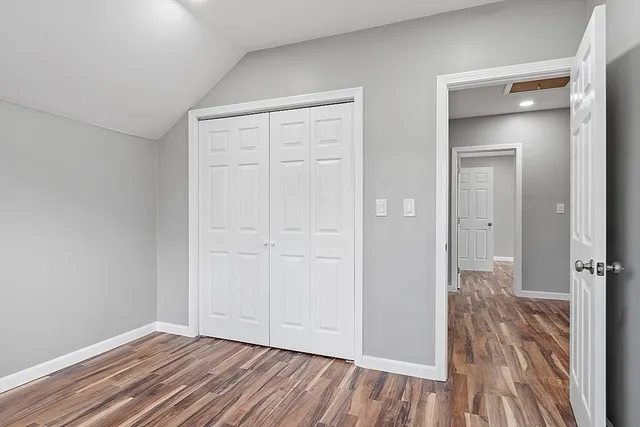 a view of a room with wooden floor and window