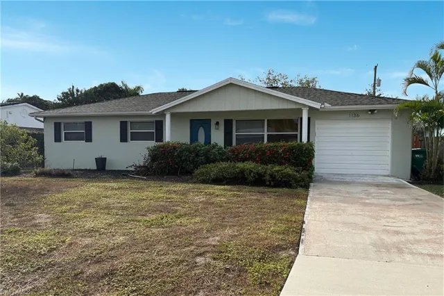 a grey house with yard